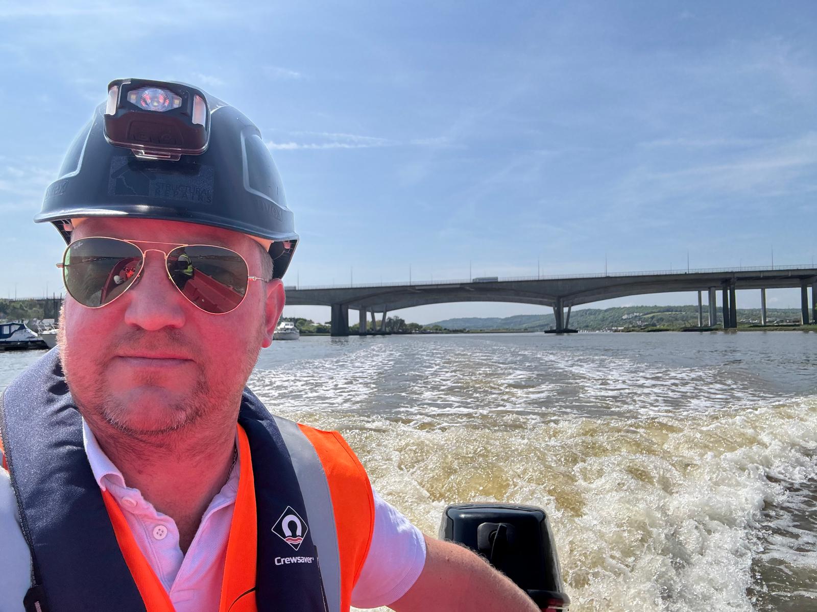 Nexus Versa survey work from a boat beside a concrete road bridge